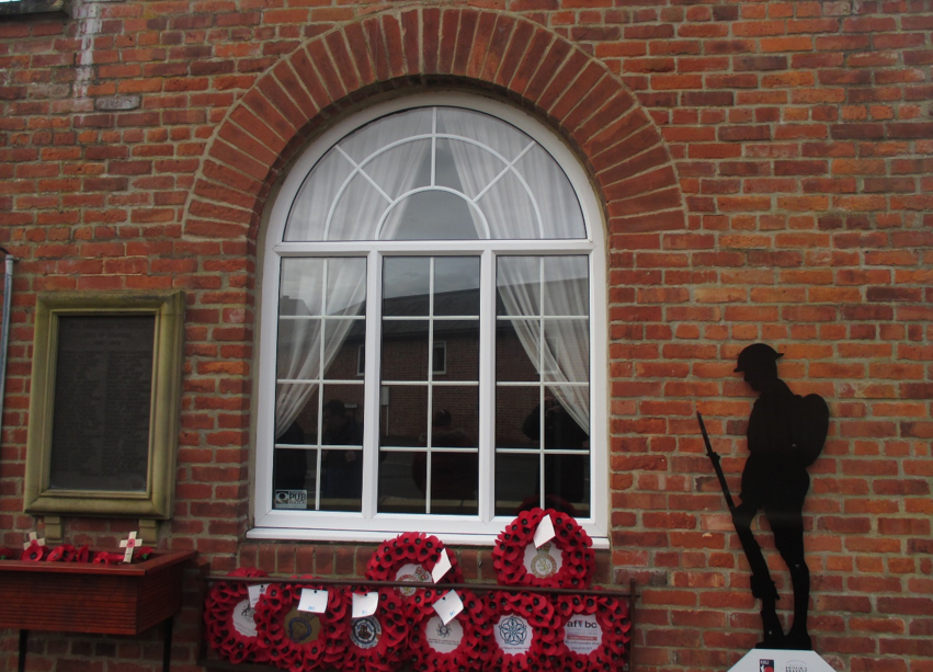 poppies on side of house